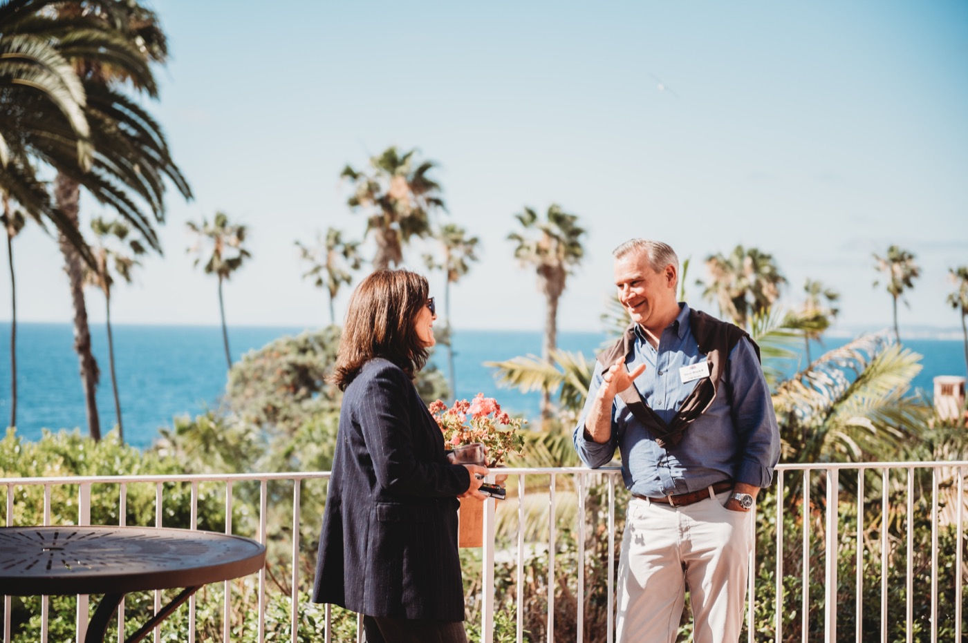 FIRE Summit 2026 attendees talking on the ocean-view terrace