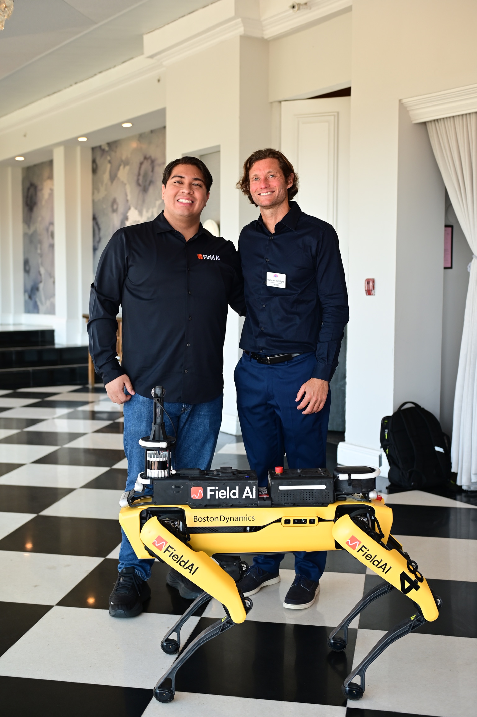 Field AI team members with a Boston Dynamics robotic dog at the Innovation Showcase